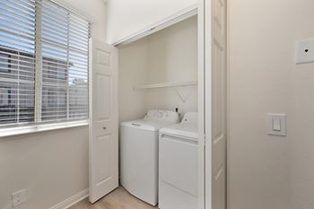 Small white laundry room with a washer and dryer.